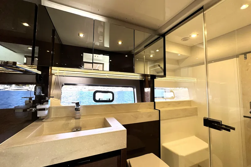 Slide: The Image of Luxurious bathroom interior of 2023 Prestige 590 yacht with modern fixtures and sea view. - 64