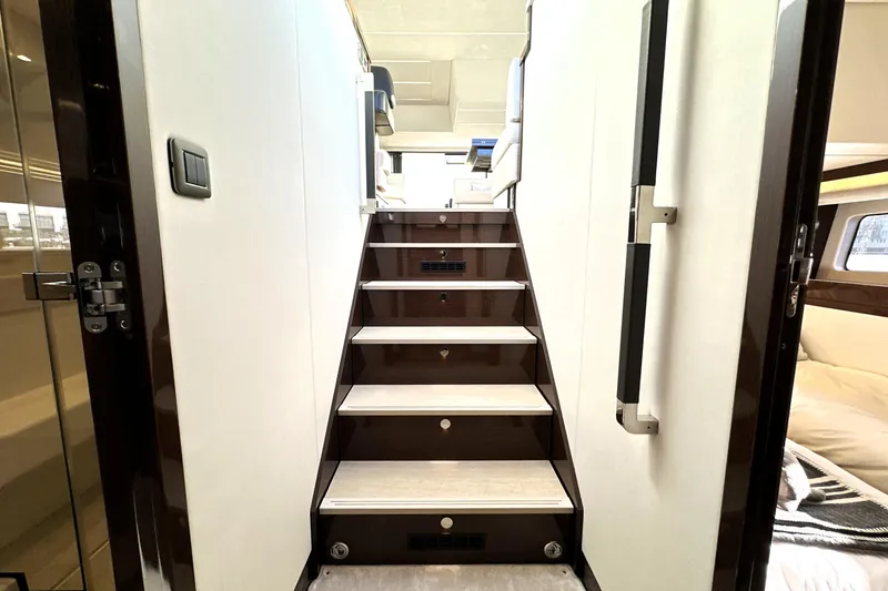 Slide: The Image of Staircase inside 2023 Prestige 590 yacht, featuring modern design and luxurious interior. - 66