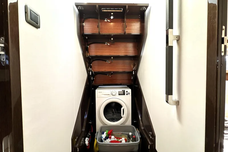 Slide: The Image of Laundry area with washing machine in 2023 Prestige 590 yacht interior. - 67
