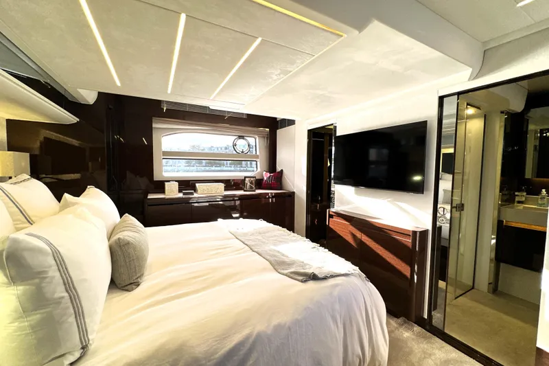 Slide: The Image of Luxurious bedroom interior of 2023 Prestige 590 yacht with modern decor and large TV. - 69