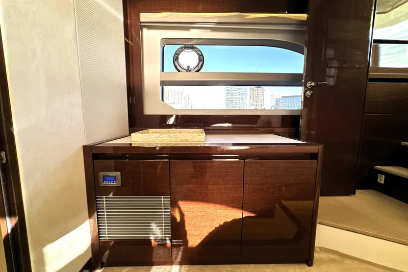 Slide: The Image of Luxurious interior of 2023 Prestige 590 yacht with sleek wood cabinetry and modern window design. - 73