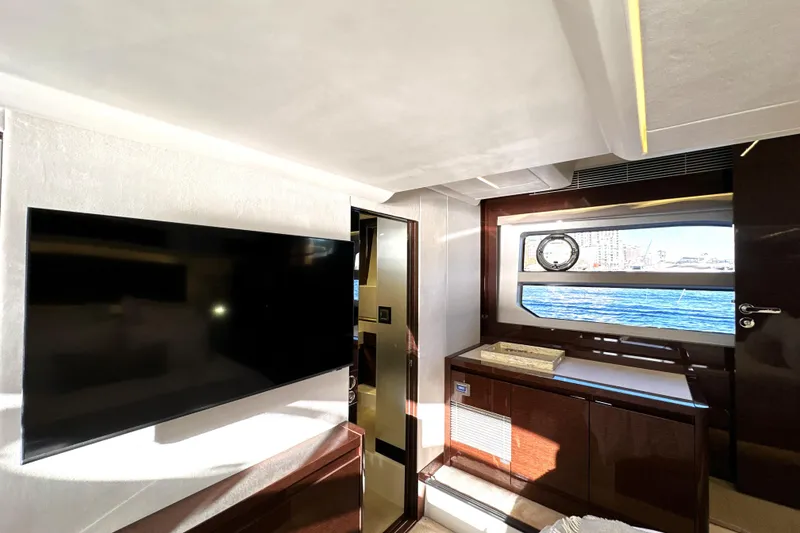 Slide: The Image of Luxurious interior of 2023 Prestige 590 yacht with TV and ocean view window. - 74