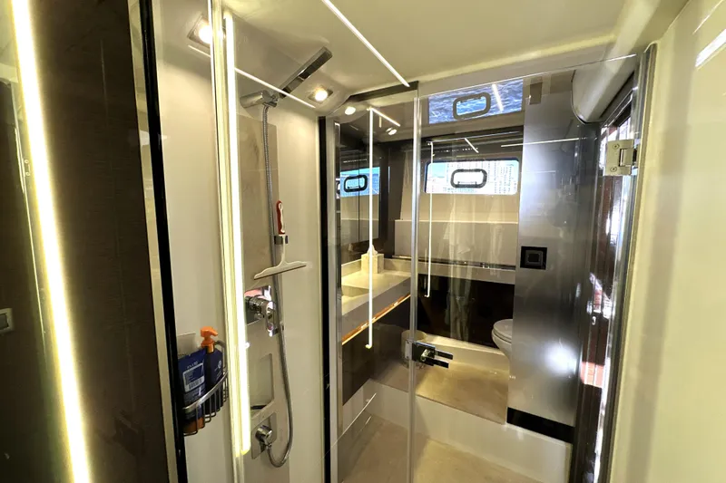 Slide: The Image of Luxurious bathroom interior of 2023 Prestige 590 yacht, featuring modern fixtures and elegant design. - 76