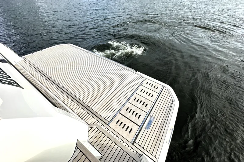 Slide: The Image of 2023 Prestige 590 yacht deck overlooking calm water. - 9