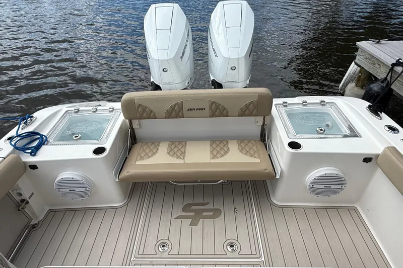 Slide: The Image of 2023 Sea Pro 320 DLX Offshore boat interior with dual engines and seating. - 10