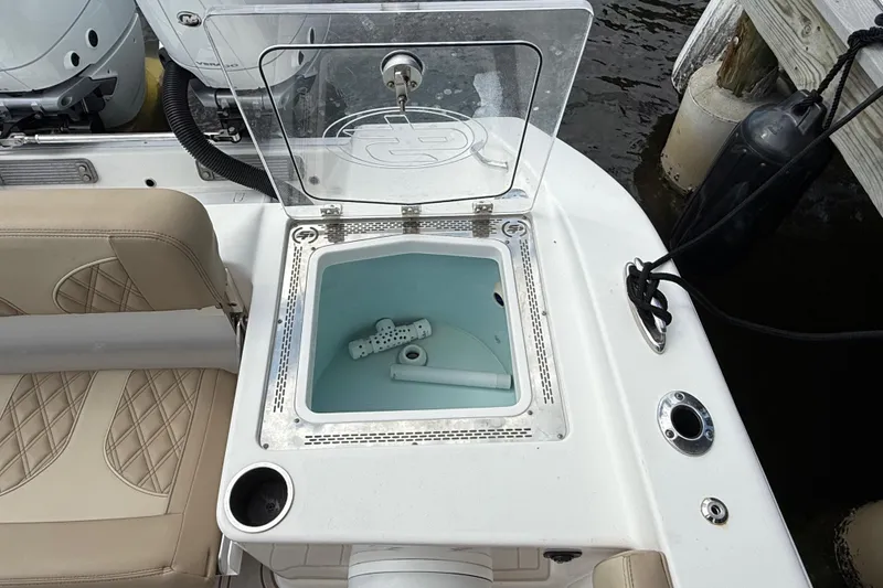 Slide: The Image of 2023 Sea Pro 320 DLX Offshore boat with open livewell and beige seating. - 11