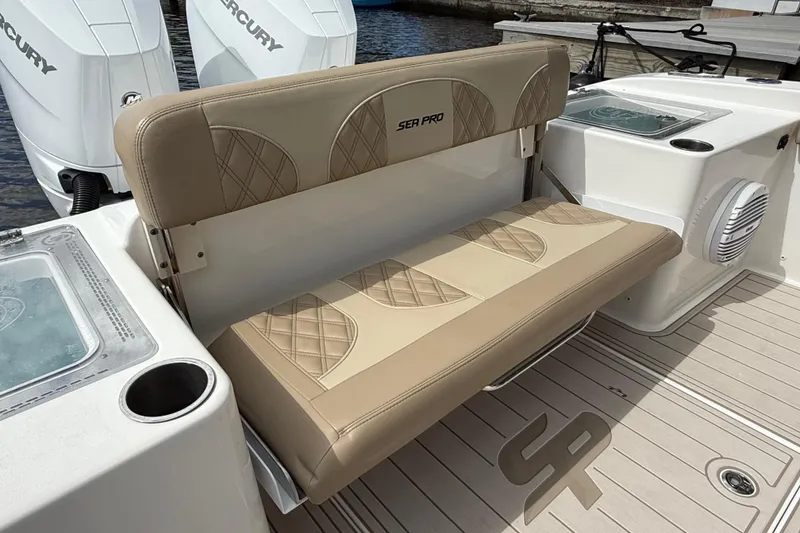 Slide: The Image of 2023 Sea Pro 320 DLX Offshore boat with beige seating and dual Mercury engines. - 13