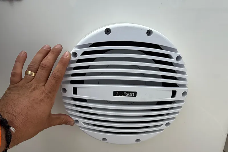 Slide: The Image of Hand near Audison speaker on 2023 Sea Pro 320 DLX Offshore boat. - 16