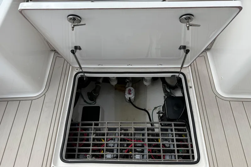 Slide: The Image of Open hatch of 2023 Sea Pro 320 DLX Offshore boat showing internal wiring and components. - 18