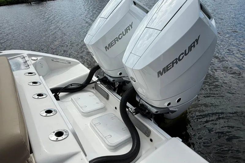 Slide: The Image of 2023 Sea Pro 320 DLX Offshore boat with dual Mercury outboard engines on water. - 19
