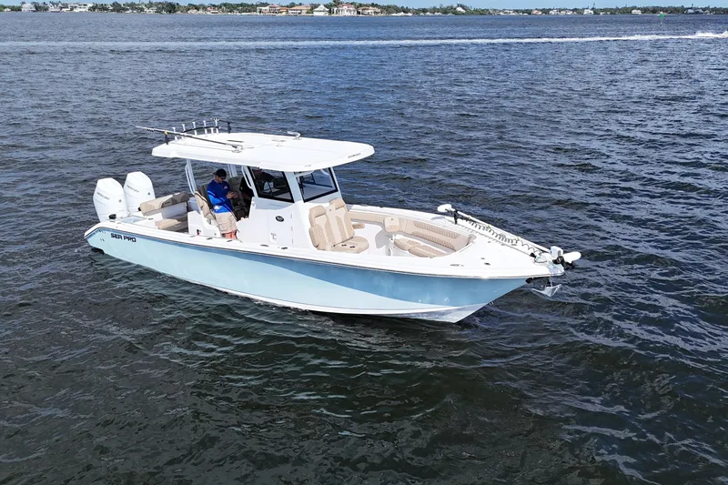 Slide: The Image of 2023 Sea Pro 320 DLX Offshore boat cruising on open water. - 2