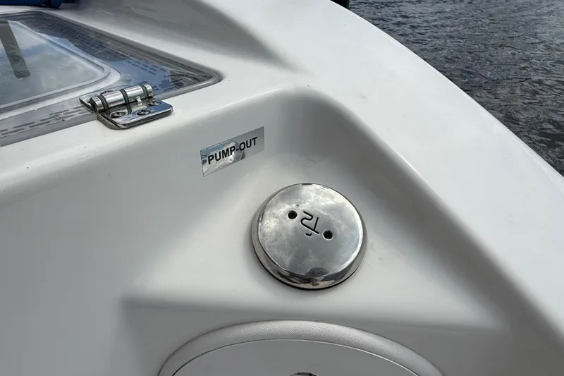 Slide: The Image of 2023 Sea Pro 320 DLX Offshore boat pump-out valve on deck near water. - 21