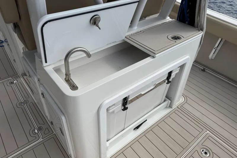 Slide: The Image of 2023 Sea Pro 320 DLX Offshore boat sink and storage area on deck. - 24