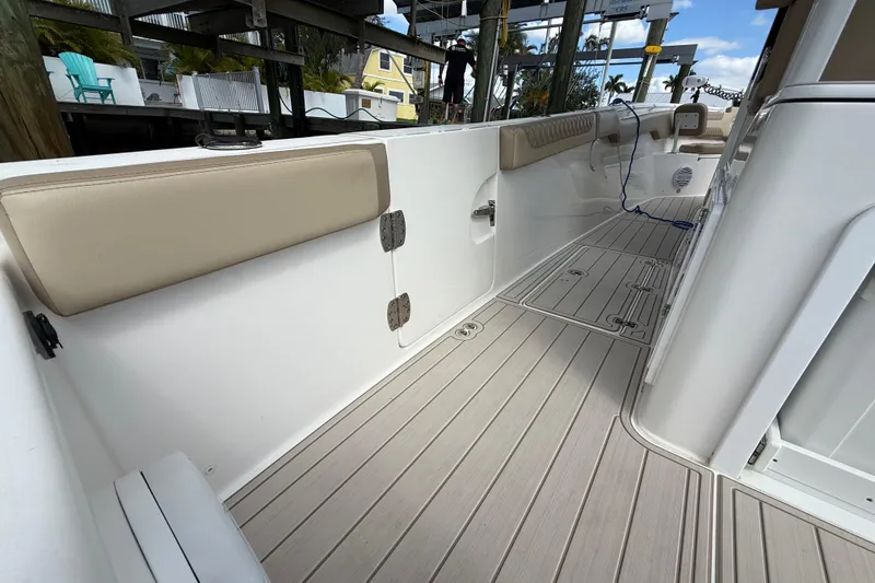 Slide: The Image of 2023 Sea Pro 320 DLX Offshore boat deck with cushioned seating and sleek design. - 26