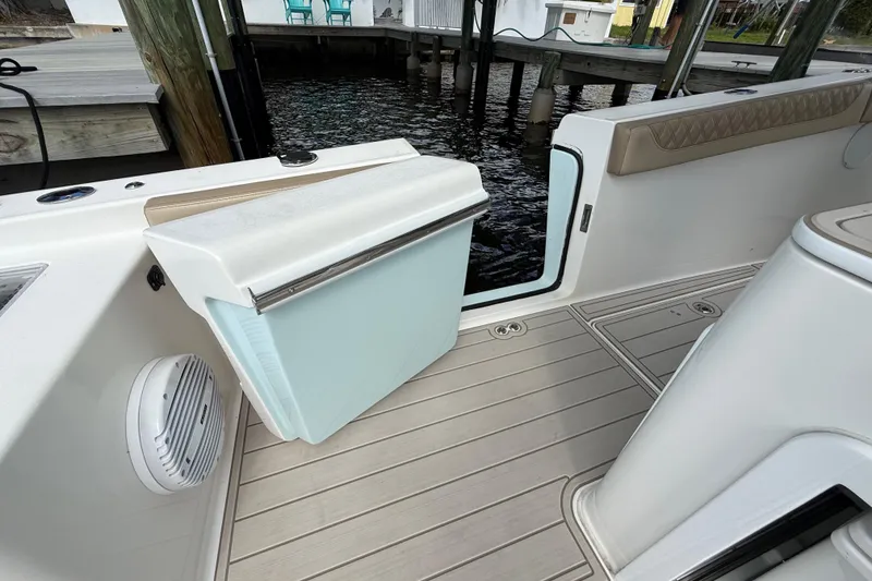 Slide: The Image of 2023 Sea Pro 320 DLX Offshore boat interior with seating and storage features. - 28