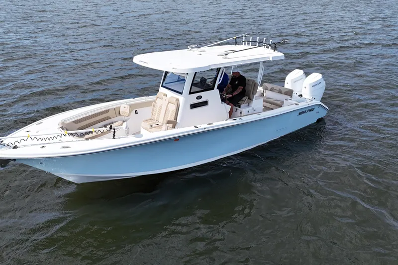 Slide: The Image of 2023 Sea Pro 320 DLX Offshore boat on open water, featuring dual engines. - 3