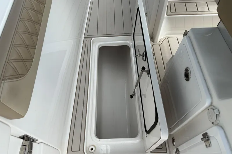 Slide: The Image of 2023 Sea Pro 320 DLX Offshore boat interior storage compartment, open lid view. - 31