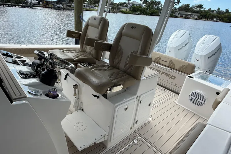 Slide: The Image of 2023 Sea Pro 320 DLX Offshore boat interior with dual seats and Mercury engines. - 35