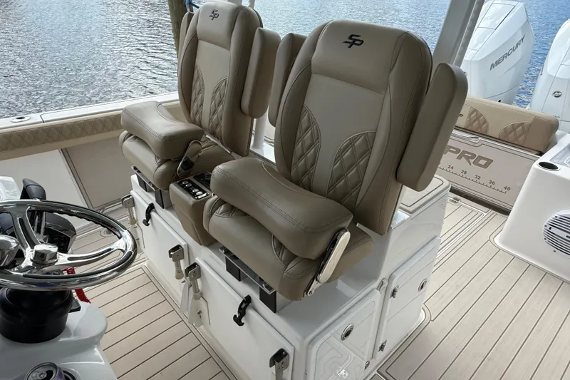 Slide: The Image of 2023 Sea Pro 320 DLX Offshore boat interior with luxurious seating and steering wheel. - 37
