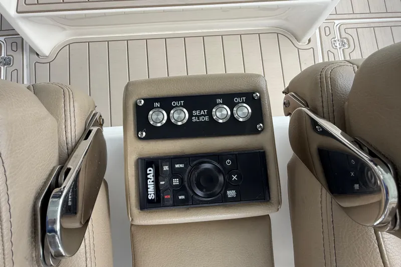 Slide: The Image of 2023 Sea Pro 320 DLX Offshore boat seat controls and Simrad navigation system. - 38