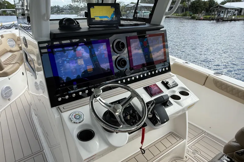 Slide: The Image of 2023 Sea Pro 320 DLX Offshore boat dashboard with advanced navigation and control systems. - 40