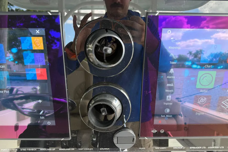 Slide: The Image of 2023 Sea Pro 320 DLX Offshore dashboard with advanced navigation displays and controls. - 43