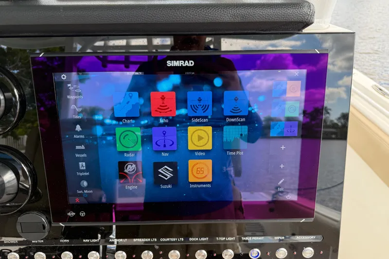 Slide: The Image of Simrad display on 2023 Sea Pro 320 DLX Offshore boat, showing navigation and radar options. - 44