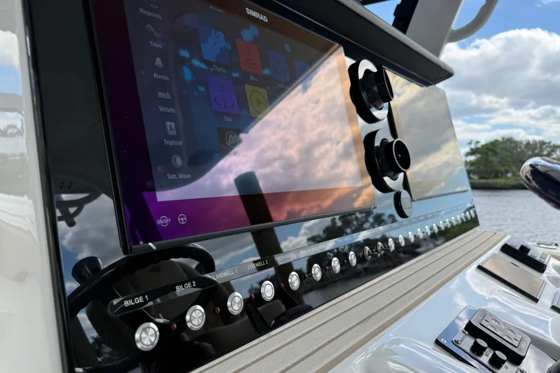 Slide: The Image of 2023 Sea Pro 320 DLX Offshore dashboard with advanced navigation system and controls. - 45