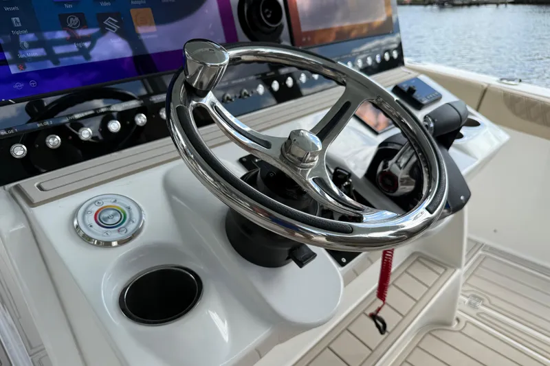 Slide: The Image of 2023 Sea Pro 320 DLX Offshore helm with modern controls and navigation display. - 46