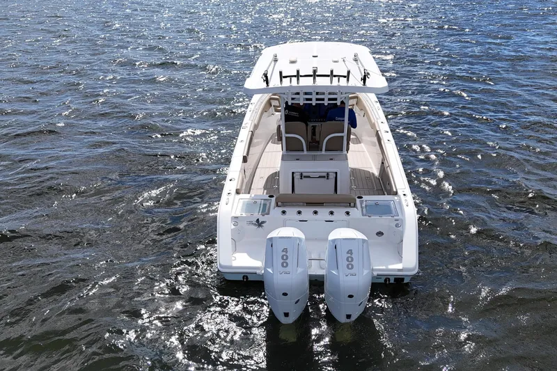 Slide: The Image of 2023 Sea Pro 320 DLX Offshore boat on water, rear view with dual engines. - 5