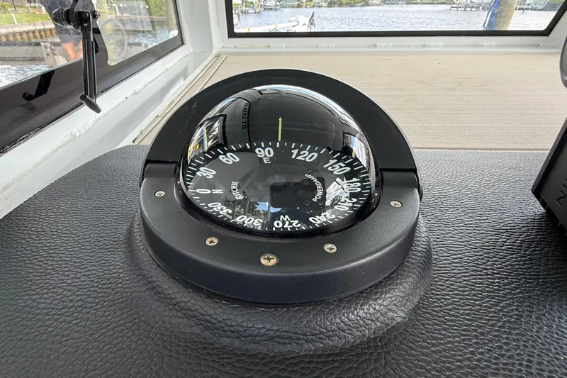 Slide: The Image of Compass on 2023 Sea Pro 320 DLX Offshore boat dashboard, showing navigation details. - 54
