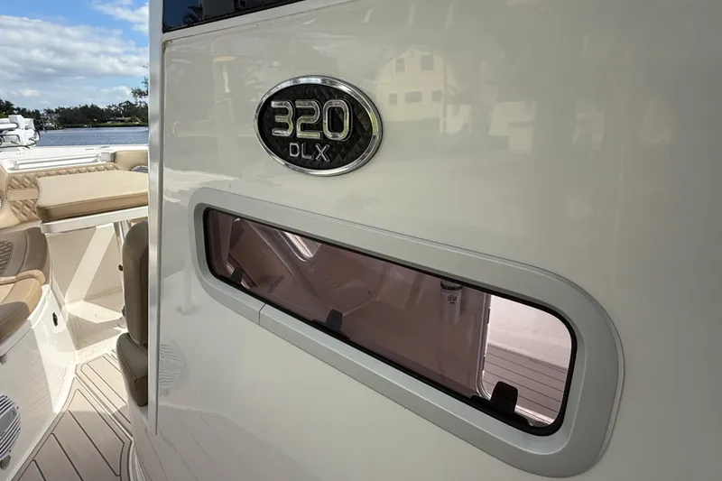 Slide: The Image of 2023 Sea Pro 320 DLX Offshore boat interior with seating and window detail. - 56