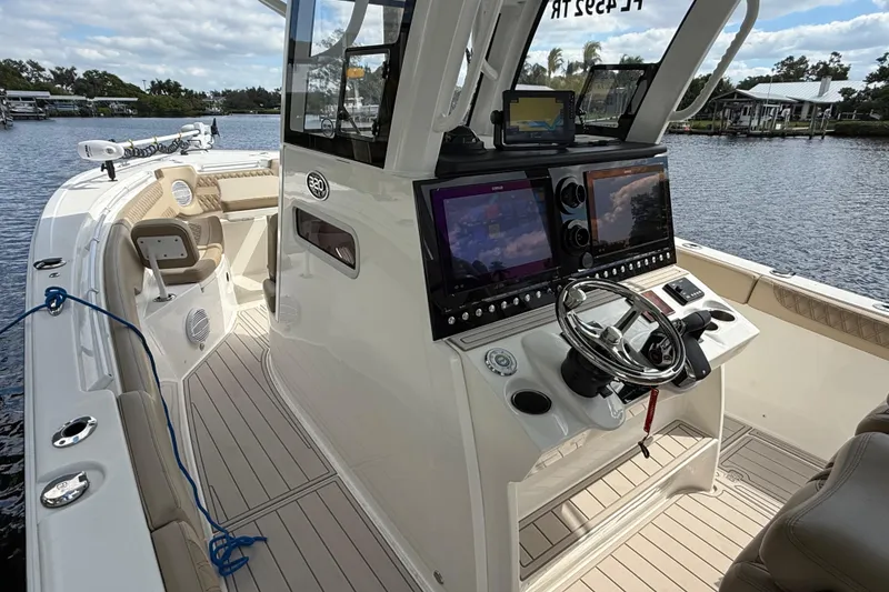 Slide: The Image of 2023 Sea Pro 320 DLX Offshore boat interior with advanced navigation system and seating. - 57