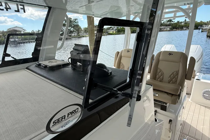 Slide: The Image of 2023 Sea Pro 320 DLX Offshore boat interior with luxurious seating and waterfront view. - 59