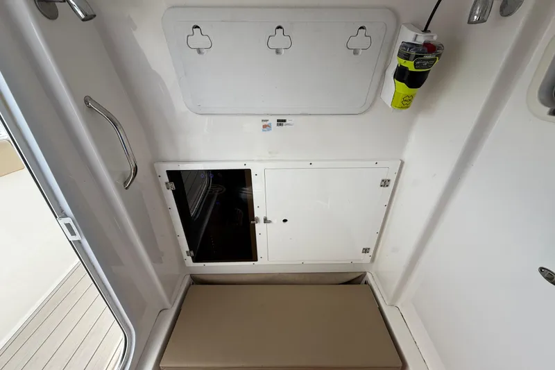Slide: The Image of 2023 Sea Pro 320 DLX Offshore interior with storage compartments and safety equipment. - 64