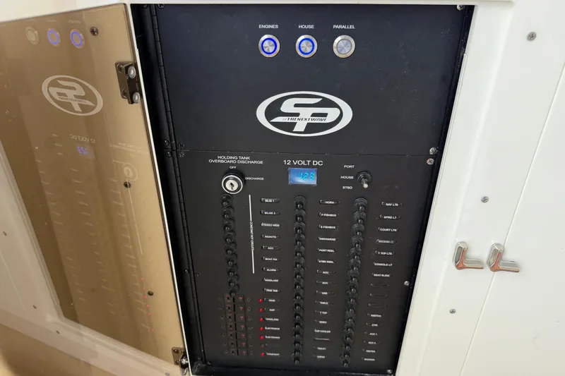 Slide: The Image of Control panel of 2023 Sea Pro 320 DLX Offshore boat, featuring 12V DC switches. - 65