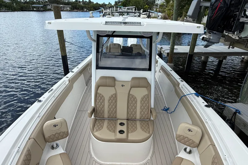 Slide: The Image of 2023 Sea Pro 320 DLX Offshore boat with luxurious seating docked by the water. - 69