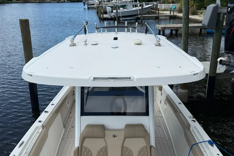 Slide: The Image of 2023 Sea Pro 320 DLX Offshore boat docked at marina, top view. - 70