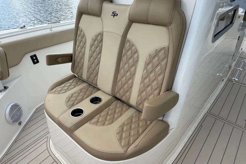 Slide: The Image of Luxurious seating on 2023 Sea Pro 320 DLX Offshore boat with cup holders and quilted design. - 71