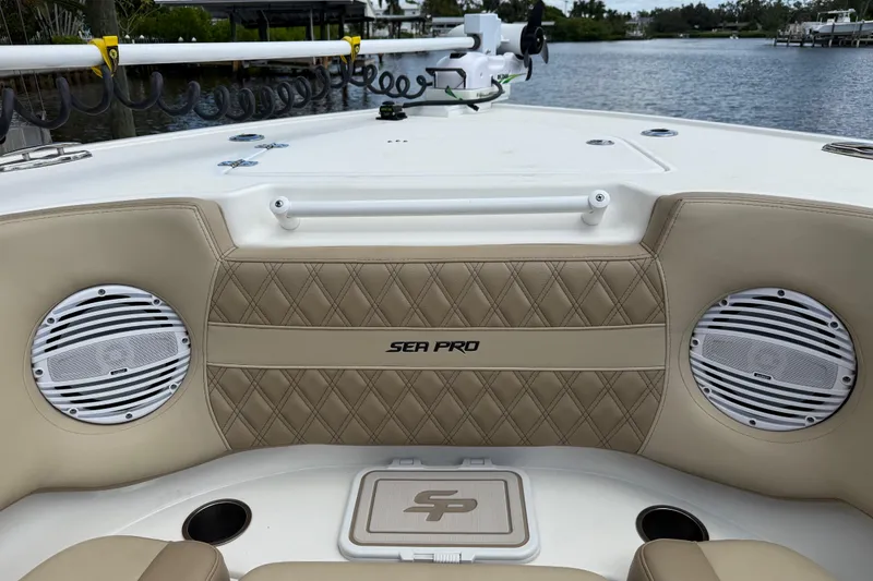 Slide: The Image of 2023 Sea Pro 320 DLX Offshore boat interior with speakers and quilted seating. - 83