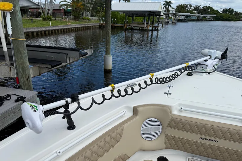 Slide: The Image of 2023 Sea Pro 320 DLX Offshore boat docked by a serene waterfront. - 84