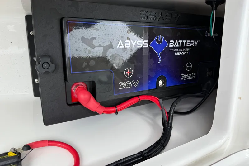 Slide: The Image of 2023 Sea Pro 320 DLX Offshore boat battery compartment with Abyss lithium battery. - 87