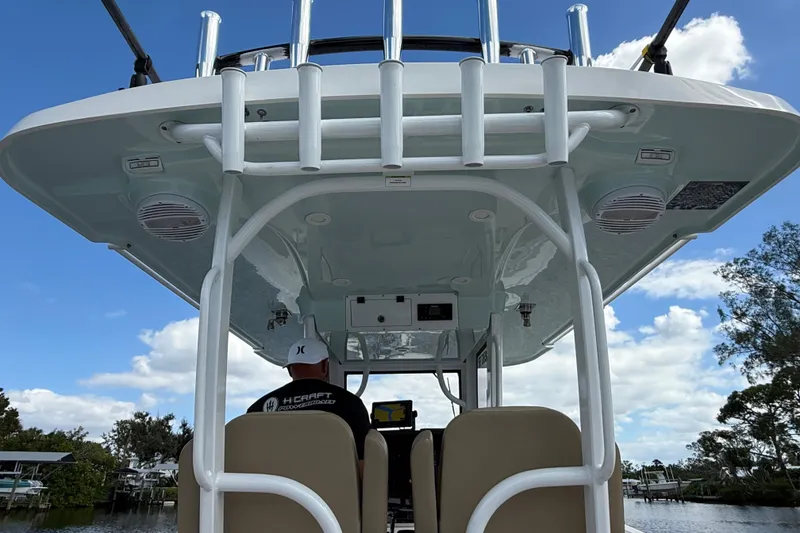 Slide: The Image of 2023 Sea Pro 320 DLX Offshore boat interior with overhead view and seating. - 89