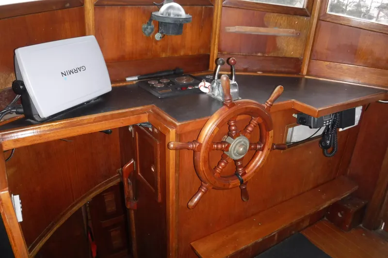 Slide: The Image of Wooden helm station of 1986 Dudley Dix Echo 38 with Garmin navigation system. - 1