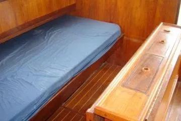 Slide: The Image of Interior of 1988 Dudley Dix Echo 38 sailboat with wooden furnishings and blue mattress. - 11