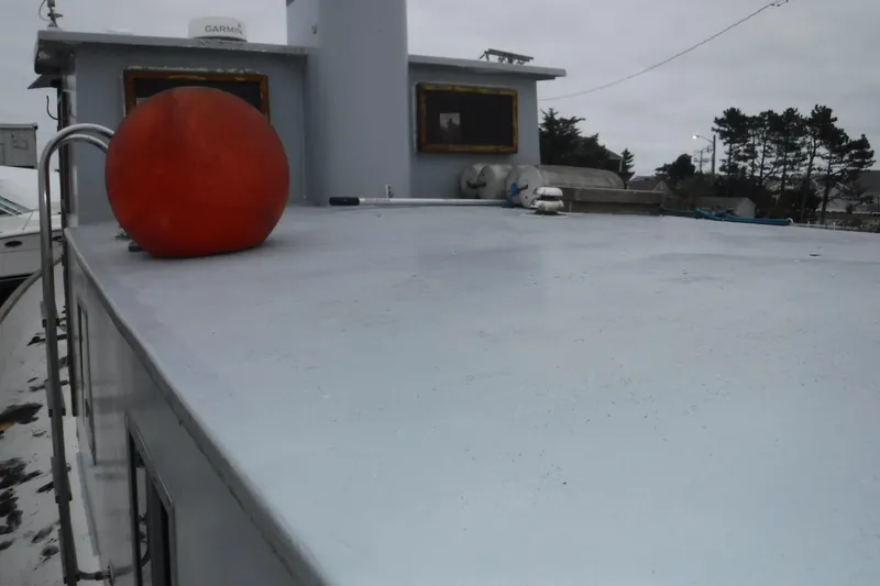 Slide: The Image of 1988 Dudley Dix Echo 38 boat deck with orange buoy and overcast sky. - 13