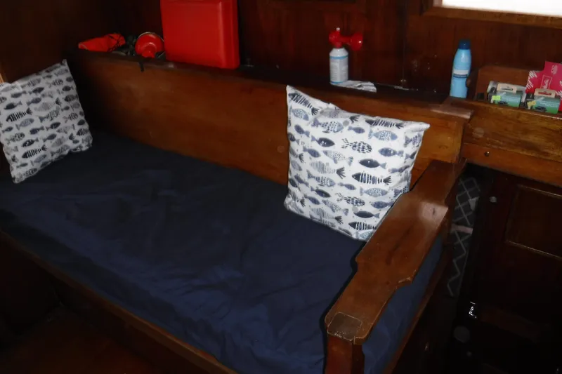 Slide: The Image of Interior of 1988 Dudley Dix Echo 38 sailboat with wooden bench and nautical-themed cushions. - 19