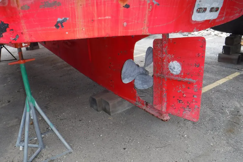 Slide: The Image of Red hull of 1988 Dudley Dix Echo 38 sailboat with visible propeller and rudder. - 22