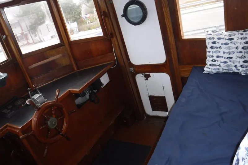 Slide: The Image of Interior of 1986 Dudley Dix Echo 38 boat with wooden helm and cozy cabin. - 3