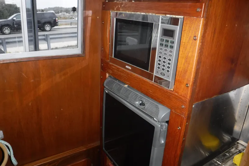 Slide: The Image of Wooden interior of 1986 Dudley Dix Echo 38 with built-in microwave and oven. - 5